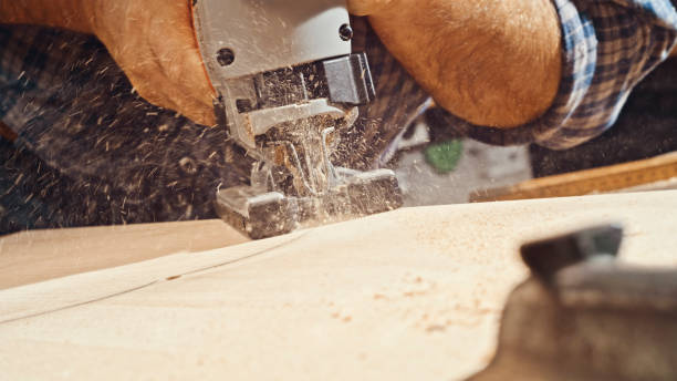 istock Male carpenter's hands cutting wooden plank 1500290834