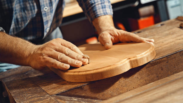 istock Carpenter's hands applying varnish to plank 1500290849