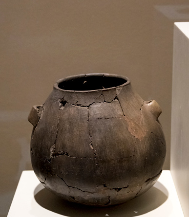 Ancient pottery from the Bronze Age. Pot Terra cotta, 2500-2250 B.C.  Alacahoyuk. Selective focus Pot. Grainy photo.