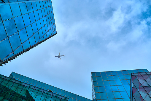 Data and Block Storage Abstracts. Looking up on reflecting office buildings watching airplane