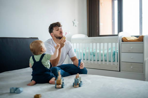 istock Dad making his baby boy soap bubbles and playing together. 1500293977