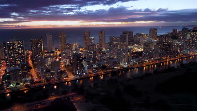Aerial view of Ala Wai Canal an artificial waterway running from Kapahulu Avenue along the length of Waikiki to the Pacific Ocean. Honolulu skyline in the background. Oahu, Hawaii. Unites States. Dusk