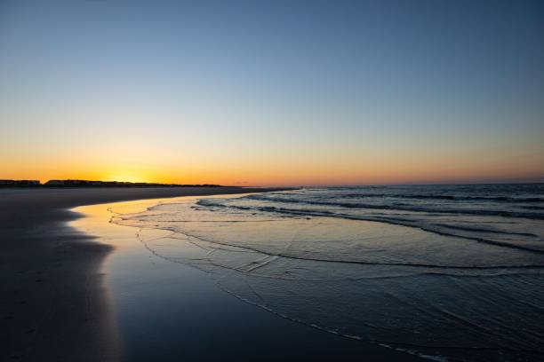istock Picturesque sunset on a beach with a tranquil ocean 1500298701
