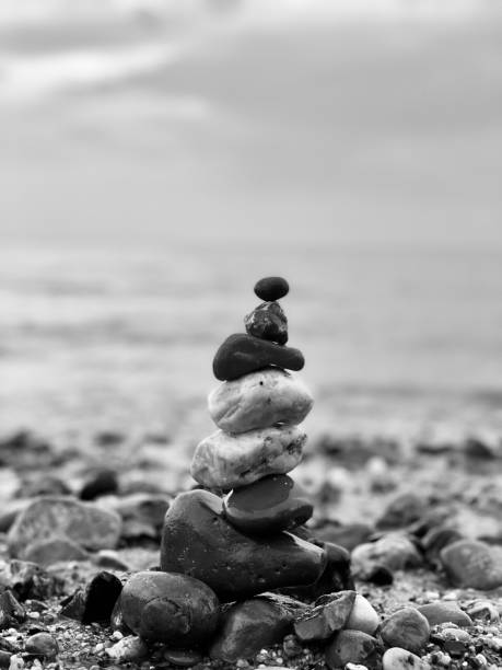 istock Vertical of a pebble tower on the beach in grayscale 1500298808