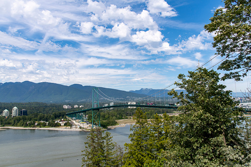 Vancouver, BC, Canada-July 2022; High level view of the suspension Lions Gate Bridge or First Narrows Bridge across the first narrows of Burrard Inlet with view on North Vancouver