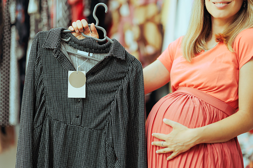 Mother to be choosing a pregnancy style dress