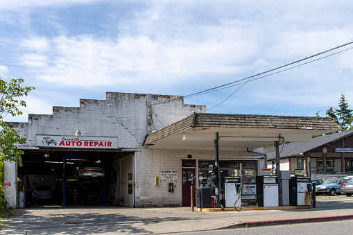 Coupeville, WA, USA-July 2022: View of an auto repair shop with gas station in a historic building in the historic waterfront district of town