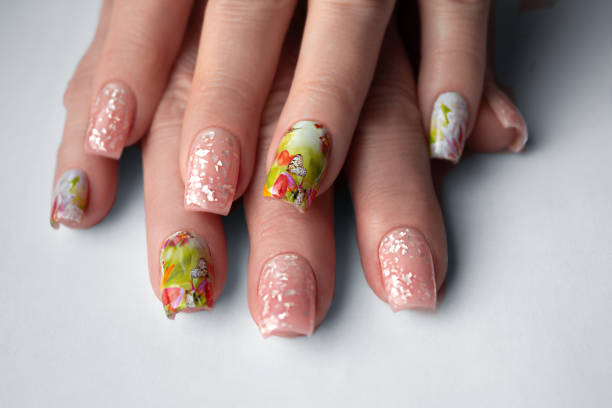 istock Light spring manicure with a floral pattern and an unusual random pattern for women 50+ 1500300717