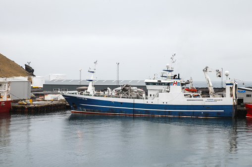 Vestmannaeyjar, Iceland - April 6, 2017: Huginn Fishing Vessel is moored in port of Vestmannaeyjar