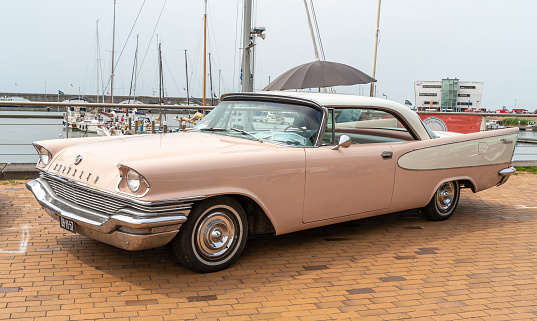 Cologne, Germany – March 27, 2019: A vintage photo of an old and broken Buick. The car is retro and is located in a backyard. The oldtimer is classic american.