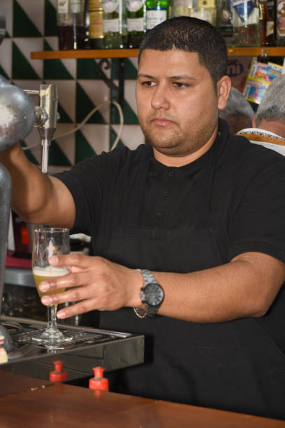 istock Waiter serving a glass of beer 1500303356