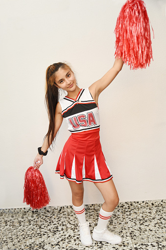 Cheerleader girl with pom poms