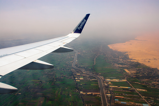 A wonderful view of the green spaces in Egypt from the window of an airplane, as Egypt is considered one of the agricultural countries and is characterized by a mild climate suitable for agriculture, with the presence of the Nile River that feeds Egypt with fresh water suitable for agriculture