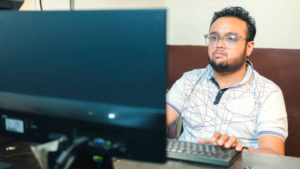 istock Indian young businessman working on computer in the office. 1500304960