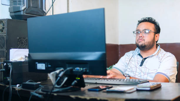 istock Indian young businessman working on computer in the office. 1500304979
