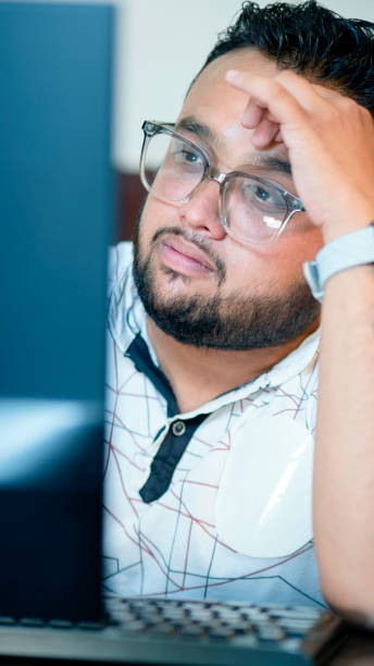 istock Stressed young businessman working on computer in the office. 1500304994