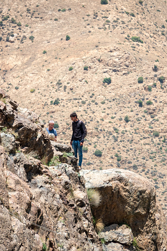 A tour guide with tourists at a remote location at Ourika Valley in Atlas Mountains, Morocco