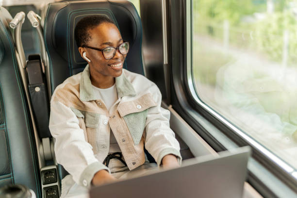 istock Young woman working on laptop computer on the train. 1500306743