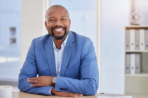 Happy black man, mature or portrait in finance office about us, company profile picture or CEO introduction. Smile, corporate or management person with investment growth, savings or financial ideas