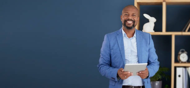 black man, business and tablet for corporate management, planning or strategy on mockup at the office. portrait of confident african american male ceo holding touchscreen for marketing on copy space - male african descent africa ethnic imagens e fotografias de stock