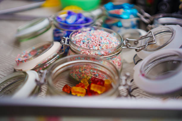 containers with sugar sprinkles for desserts and gummy bears. topping for ice cream and sweets.