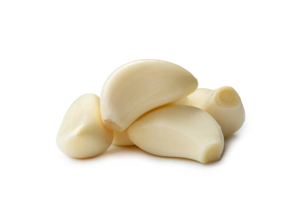 istock Peeled garlic cloves in stack isolated on white background with clipping path. 1500309669