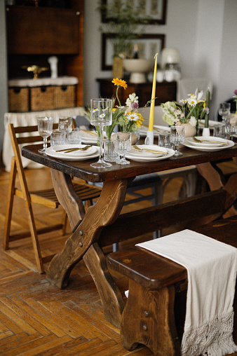 serving the table with fresh flowers and candles