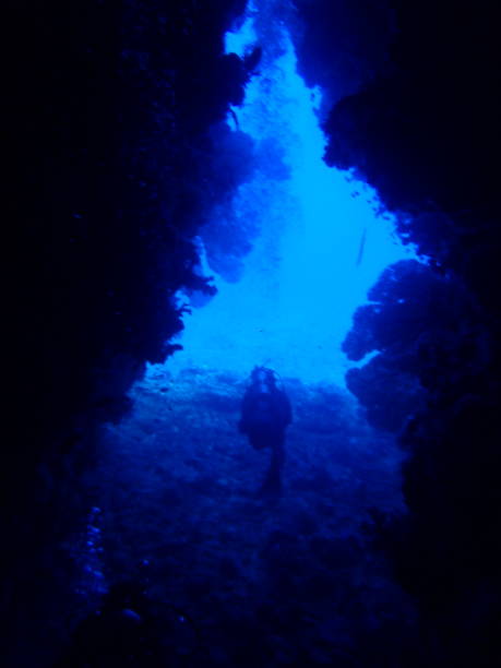 istock Scuba diver swims out of cave 1500310797