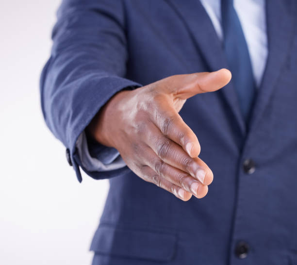istock Open hand shake, studio closeup and man with welcome, hiring opportunity and partnership by white background. Recruitment expert, businessman or hr manager with shaking hands in agreement by backdrop 1500311599