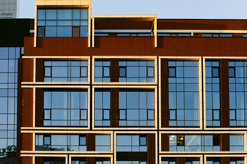 Close-up of the facade of a modern residential building, windows, balconies.