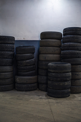 Stacks of used tires in auto repair service