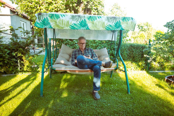 istock Senior man using smart phone in garden 1500316659