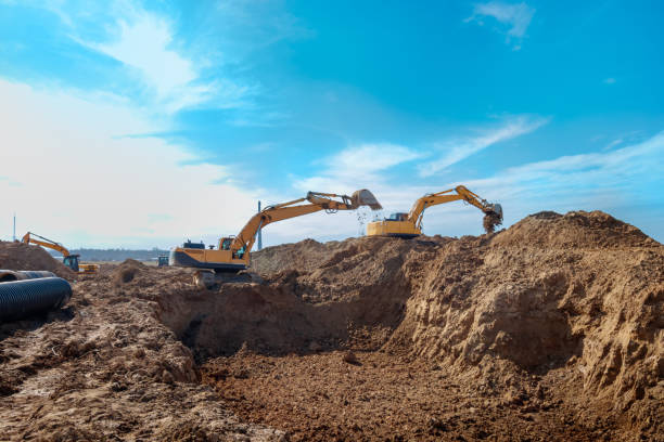 istock Two Excavator are digging soil in the construction site on sky background,with white fluffy cloud 1500319731