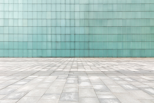 Square pavement and wall building background. Urban architectural landscape in China
