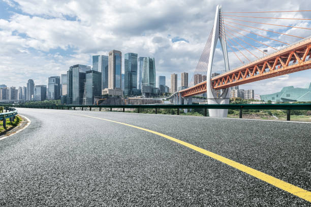 istock Empty asphalt road and city buildings skyline 1500321578