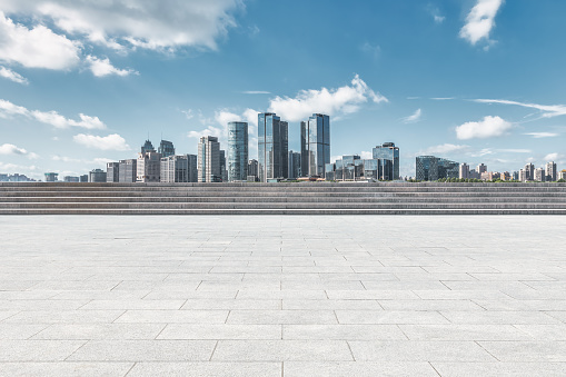 Empty square floor and modern city commercial buildings in Beijing, China.