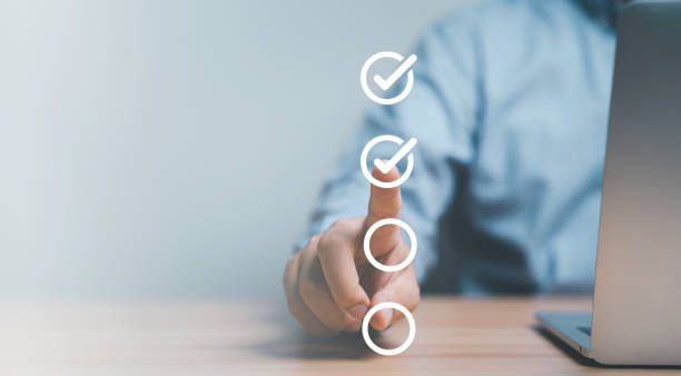 istock Businessman hand point to tick correct sign mark in checkbox for quality document control checklist and business approve project concept. 1500322284