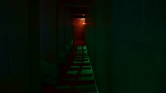 Abstract green corridor with red light at the end