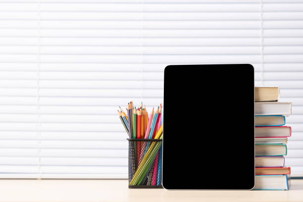 istock Tablet with colorful pencils and stack of books 1500330538