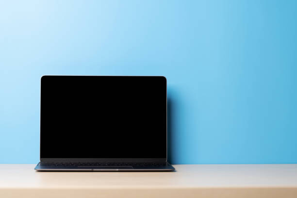 istock Laptop with blank screen on wooden table 1500331078