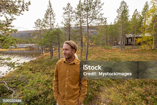 istock Man walking in a pine tree forest in autumn 1500332686