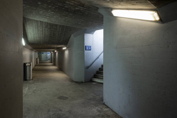 istock Long concrete pedestrian corridor under the train station with the staircase. 1500332759
