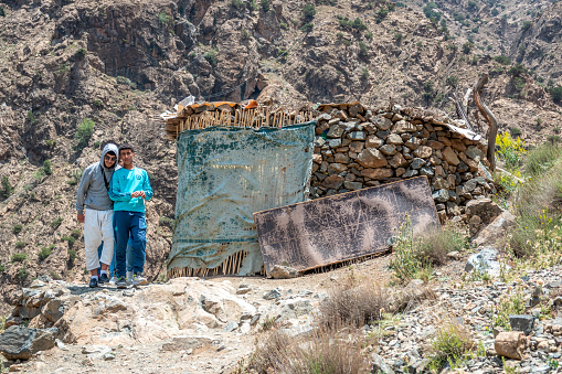Two men standing near a Built Structure at Ourika Valley in Al Haouz Province in Atlas Mountains, Morocco
