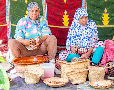 Two Berber women making Argan Oil in Ourika Valley at High Atlas Mountains, Morocco