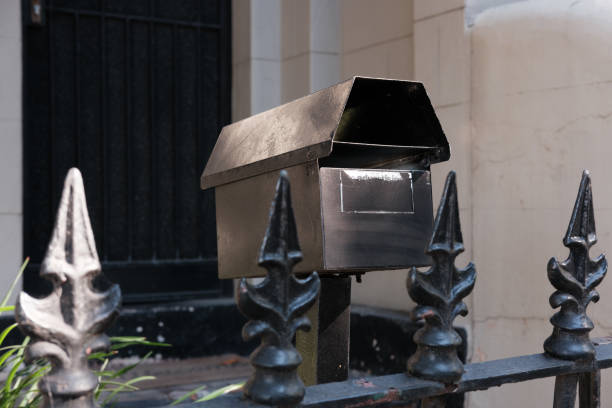 istock Black metal mailbox on a fence 1500337190