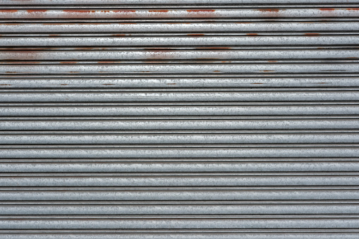 An old rusty silver garage door.