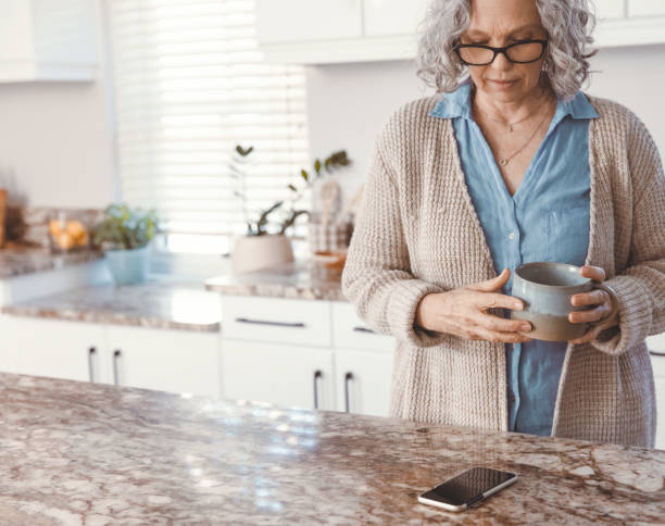 istock Senior woman standing in the kitchen 1500338575