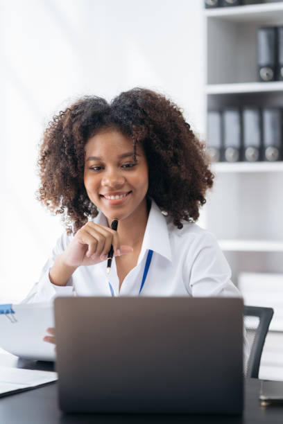 istock Businesswomen hand working with tablet and laptop computer with documents on office desk in modern office. 1500338610