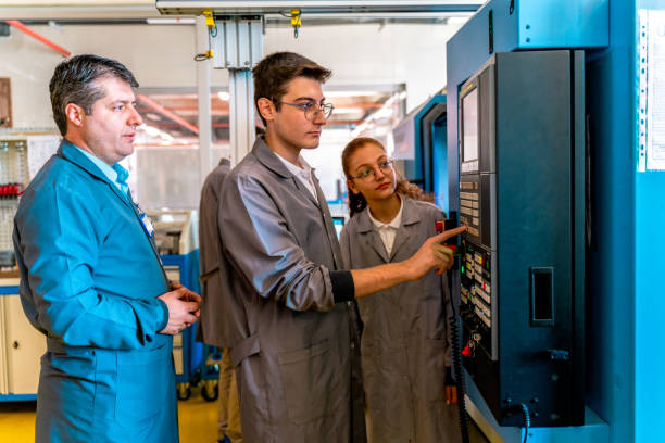 istock Group of Young People in Technical Vocational Training with A CNC Machine At School 1500338898