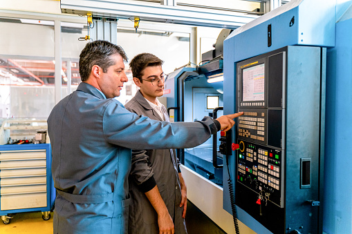 Group of Young People in Technical Vocational Training with A CNC Machine At School